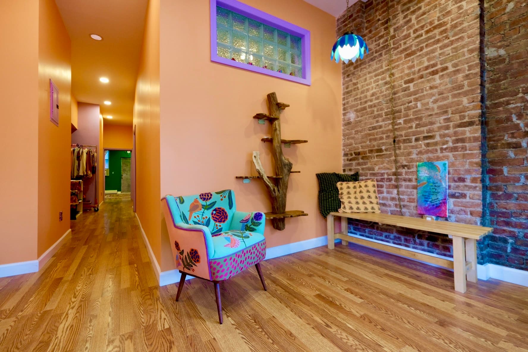 Entryway hallway showcasing artwork and warm lighting